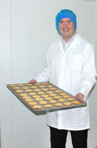 Alasdair Maclean of Stag Bakeries with a tray of original water biscuits Biscuits